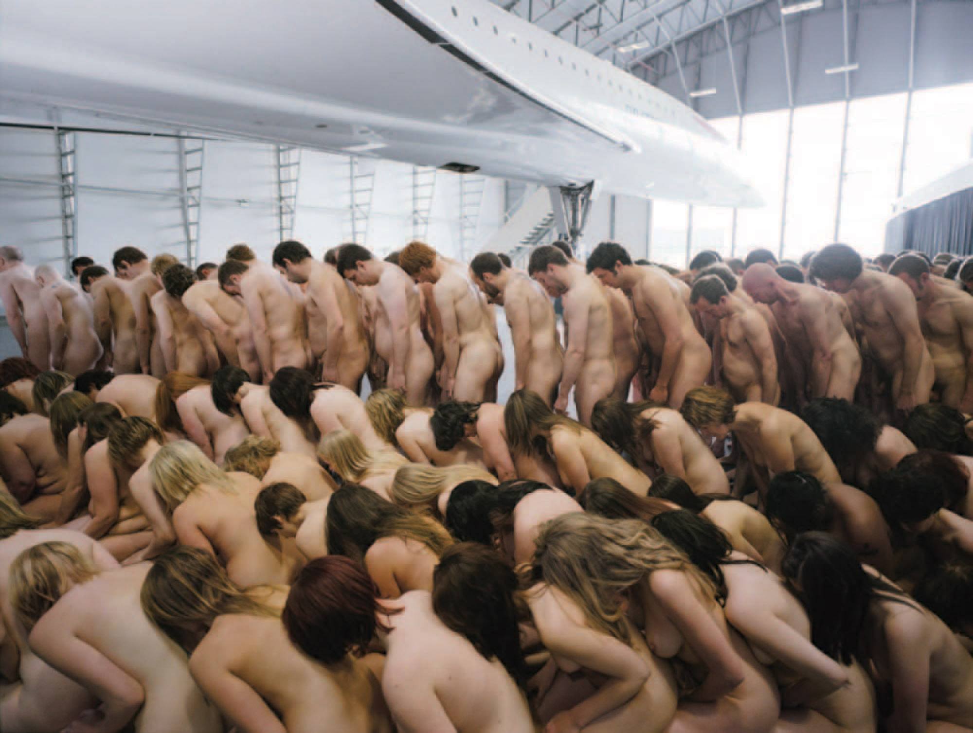 is best known for organizing large-scale nude shoots. 